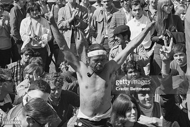 Unidentified Yippie gives V for Victory salute, during a rally of Yippies and hippies in Lincoln Park here 8/26. 8/26/1968