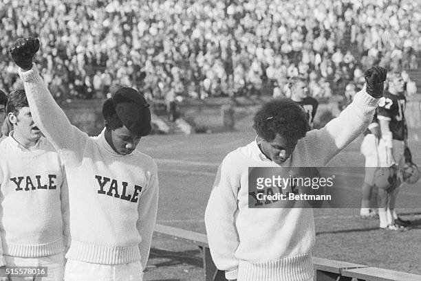 Yale cheerleaders Greg Parker and Bill Brown give the Black Power salute during the National Anthem starting the Yale-Dartmouth football game in the...