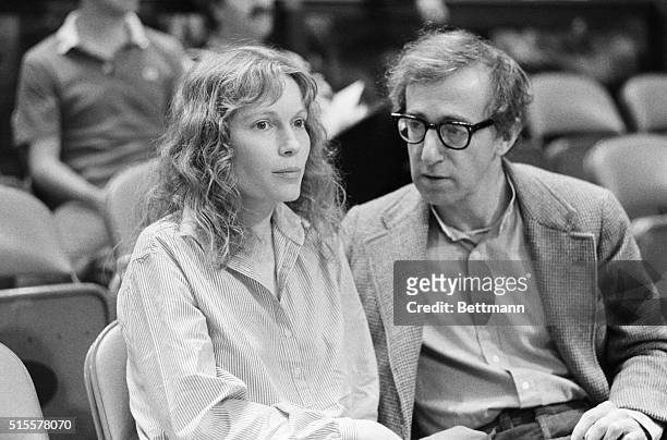 Mia Farrow & Woody Allen attend a New York Knicks-Philadelphia 76ers basketball game in Madison Square Garden in 1983.