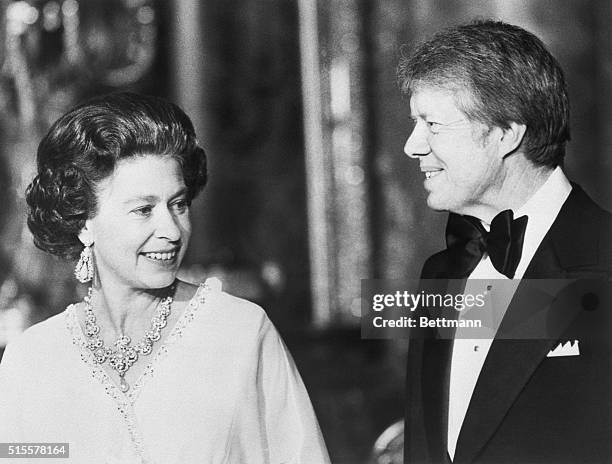 President Jimmy Carter stands with Queen Elizabeth at Buckingham Palace, at a dinner for summit leaders.