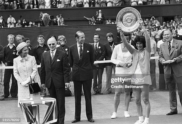 Virginia Wade holds up the trophy for winning the 1977 Wimbledon Women's Singles championship. Beside her stands her opponent Betty Stove, the Duke...