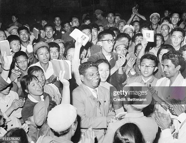 Red Guards, waving their copies of the Little Red Book greet members of a Ceylon-China friendship delegation who have come to China to take part in...