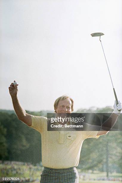 Golfer Jack Nicklaus raises his club and ball in victory after winning the Masters Tournament in 1986.