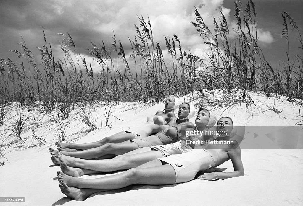 Women Sunbathing At The Beach