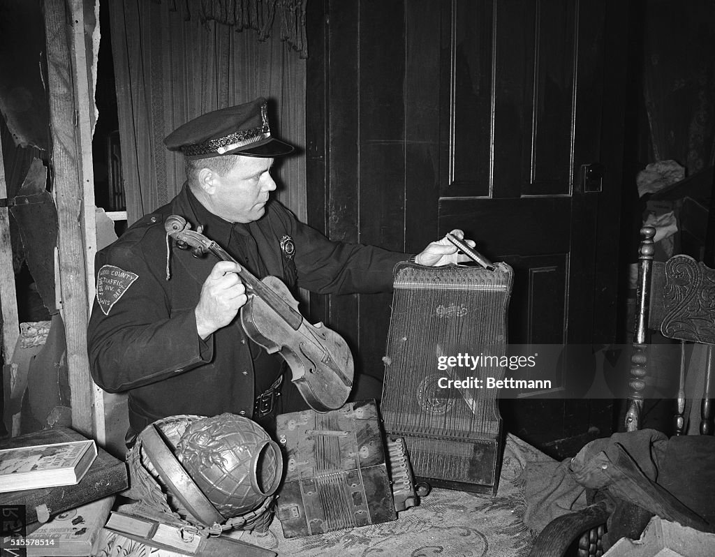 Trooper Looks At Instruments In Home