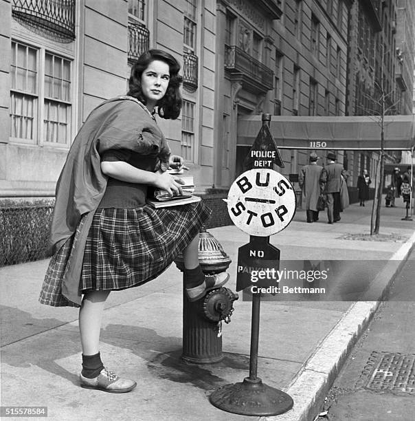 New York, NY: Oona O'Neill when she was 16 years old and a student in New York, waiting for a bus at Madison Avenue. Photograph.