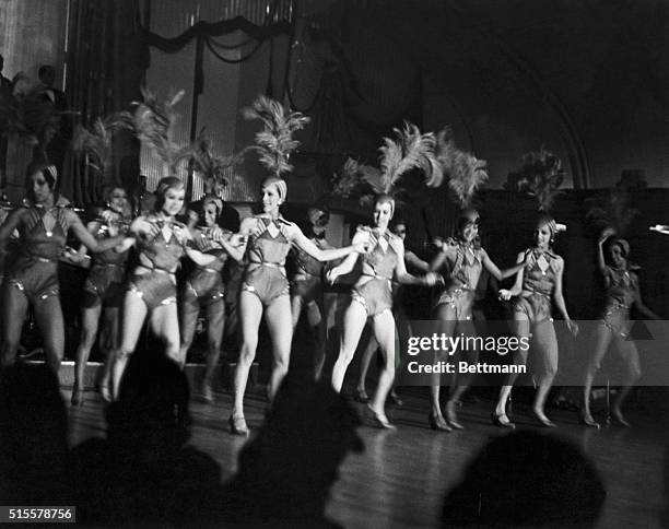 Floor show from the famous Harlem night club, "The Cotton Club", featuring leggy row of chorus girls. Photograph, 1920's.