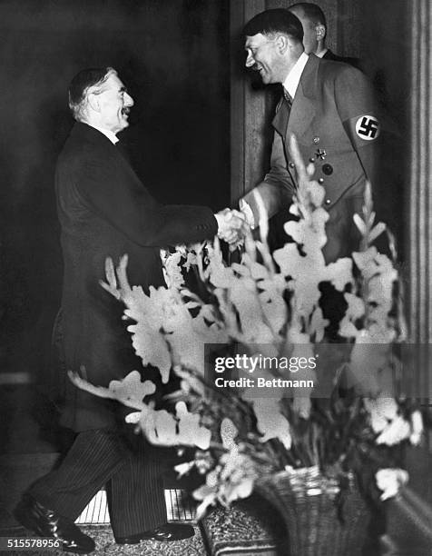 Prime Minister Neville Chamberlain is welcomed by Chancellor Adolf Hitler before a meeting. | Location: Godesburg, Nazi Germany.