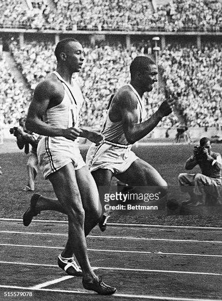 Americans Jesse Owens and Ralph Metcalfe during the 400-meter relay at the 1936 Olympic Games in Berlin.