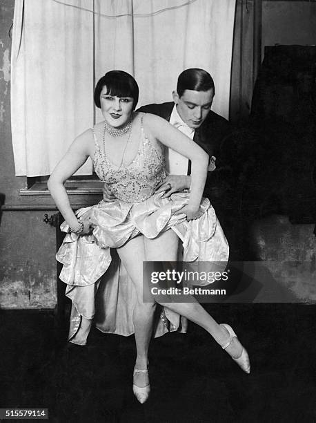 Couple demonstrating technique of dancing the Charleston. Photograph ca. 1920.