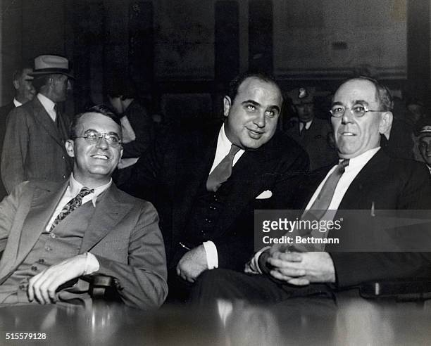 Al Capone , American gangster with lawyers at hearings of Federal Grand Jury, where he was indicted for income tax evasion. Photograph.