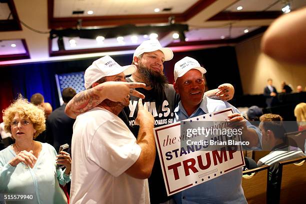 Supporters of Republican presidential candidate Donald Trump take a photograph together as they wait inside the Tampa Convention Center before a town...