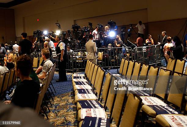 Members of the media work inside the designated media pen as they wait for Republican presidential candidate Donald Trump to arrive at a town hall...