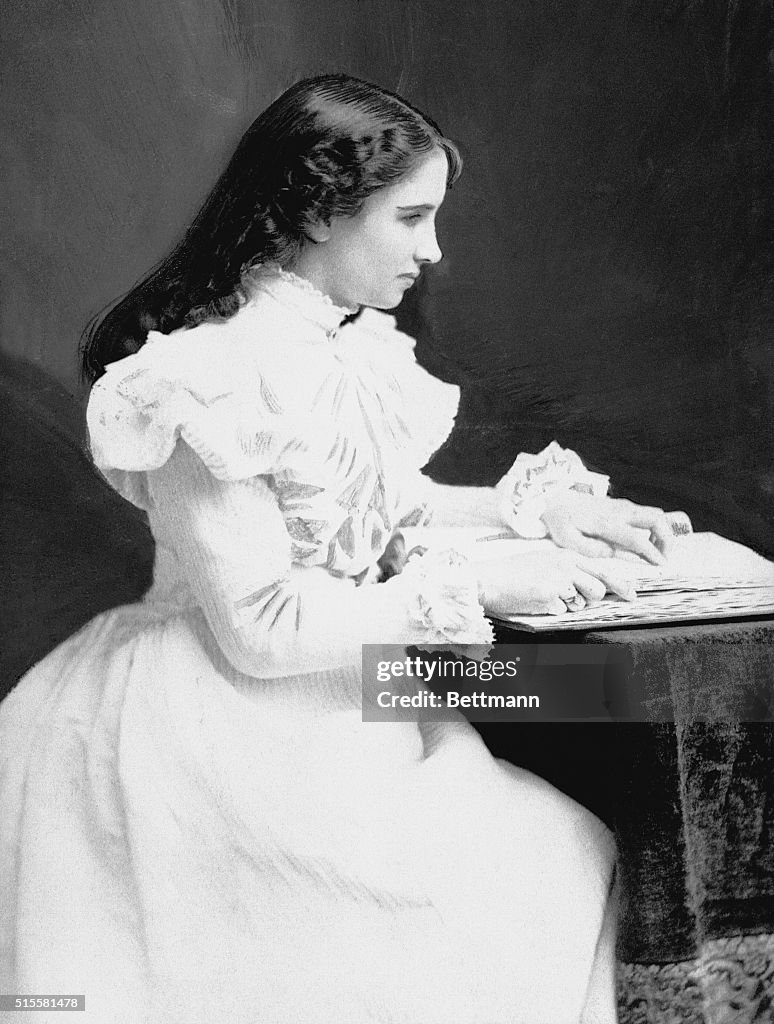 Helen Keller Sitting at a Desk