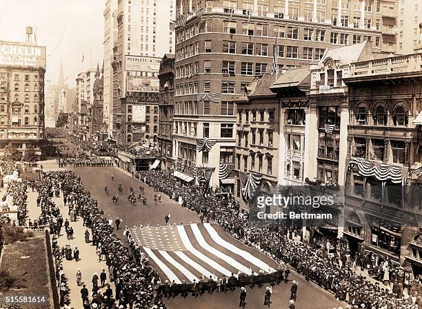 Draft parade heads up Fifth Avenue near 41st. Street. The lions of the New York Public Library are on the far left, and the spire of St. Patrick's...