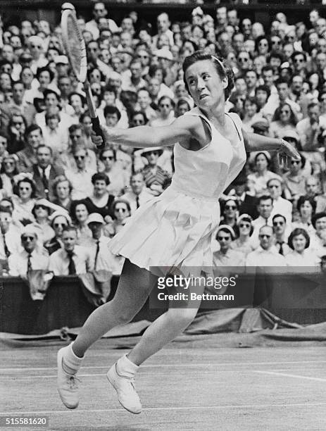 London, England: With the poise and grace of a ballerina, America's Maureen Connolly - "Little Mo" - plays a shot during her women's singles final...