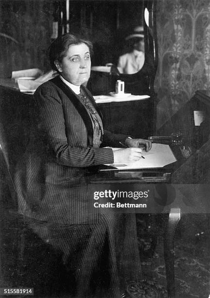 Jane Addams, American social reformer and pacifist, works at a desk.