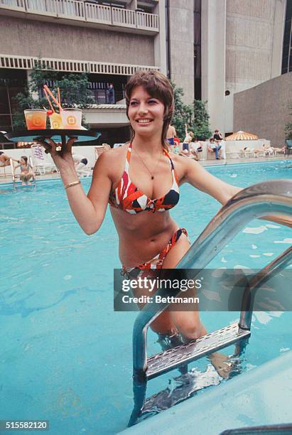 Brenda Lee attracts as many comments as the weather when she tends bar at the Hyatt Regency Hotel pool in Atlanta, where her "work clothes" consist...