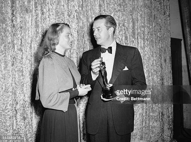 Actress Ingrid Bergman, winner of the Best Actress Oscar for her role in Gaslight, presents actor Ray Milland with the Oscar for Best Actor for his...