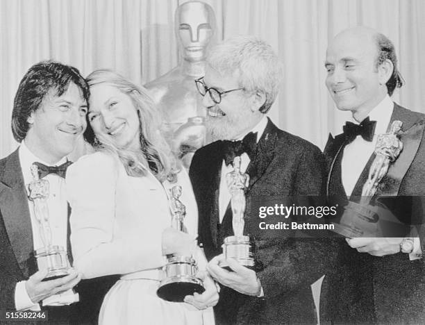 The big winners of the movie, Kramer vs. Kramer, hold up four of the Oscars won by the film at the 52nd Annual Academy Award presentations at the...