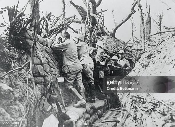 French gunners keep watch from the observation balcony of a carefully screened trench at Verdun.