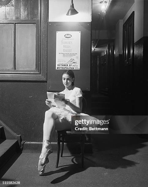 Ballet dancer Margot Fonteyn reads a letter from home between rehearsals at the Metropolitan Opera House.