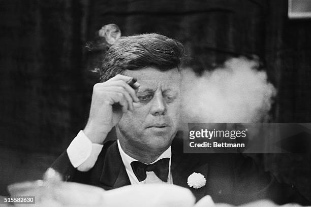 President John F. Kennedy smokes a cigar during a Democratic fundraising dinner at the Commonwealth Armory at Boston University.