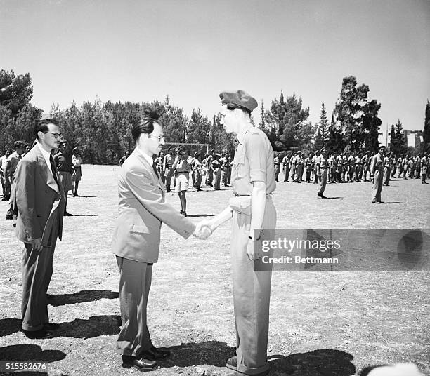 Menachem Begin shakes hands with a member of the Irgun Zvai Leumi. Begin was the leader of the Irgun Zvai Leumi, a right-wing Jewish organization...