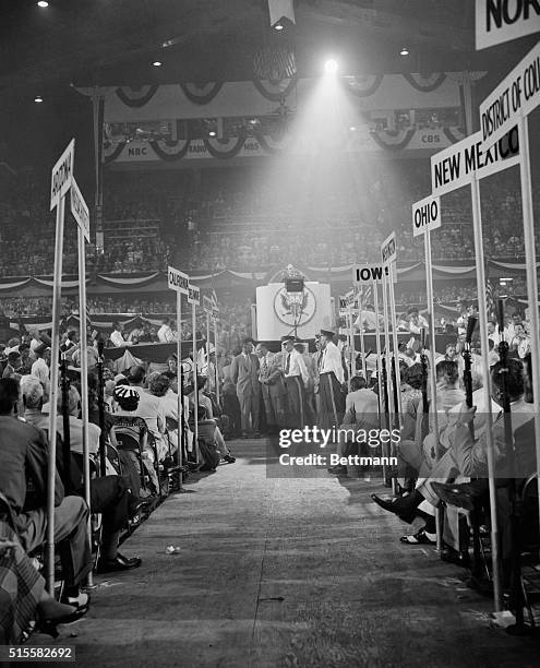 This unusual photo, shot down the center aisle between the standards of the States, shows General Douglas MacArthur on the rostrum as he began his...