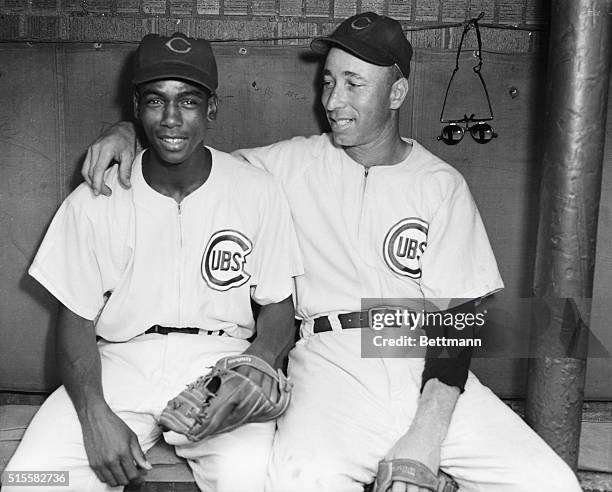 Shortstop Ernie Banks and pitcher Sam Jones of the Chicago Cubs sit in the dugout prior to the start of a baseball game against Milwaukee. Both...