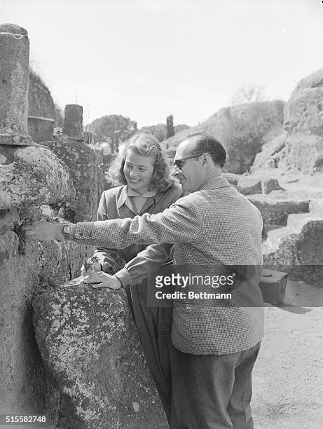 Actress Ingrid Bergman and director Roberto Rossellini inspect the Etruscan ruins. Bergman is in Italy to make a new film.