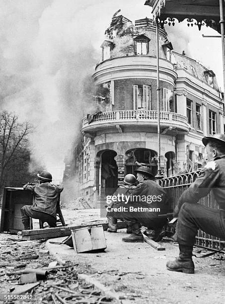 British soldiers take cover from sniper fire during a battle in a key Dutch town.