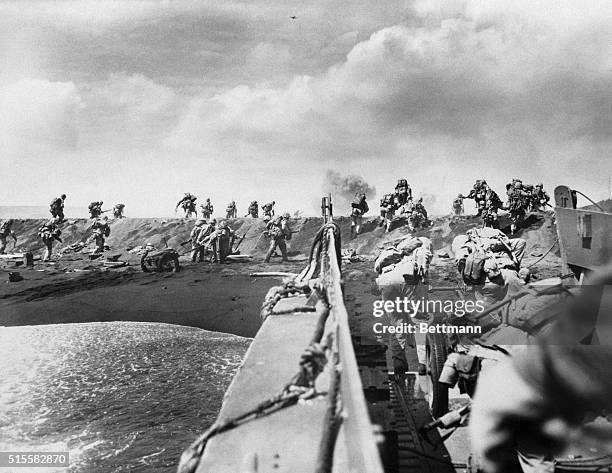 Soldiers storm a beach on Iwo Jima during the Battle of Iwo Jima.