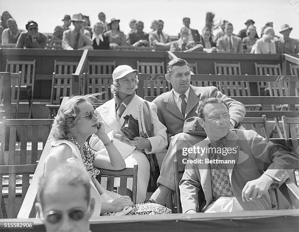 Group of celebrities watches the Beverly Hills Tennis Tournament. Actor Clark Gable sits next to tennis player Alice Marble. Gable's wife Carole...