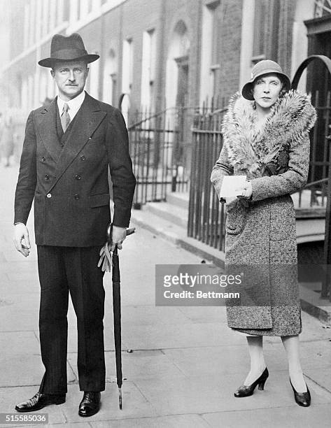 Photo shows Mr. A. Duff Cooper with his wife, Diana, leaving their London home to hand in the nomination papers at the Westminster City Hall.