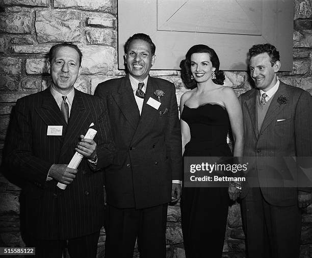Journalists and editors posing with movie actress Jane Russell on the set of The Las Vegas Story on May 9, 1951. Left to right are: editor in chief...