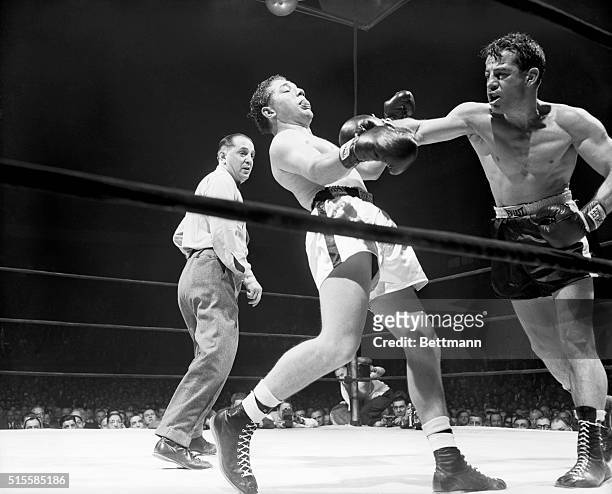 Rocky Graziano follows through after a hard right to the jaw of opponent Tony Janiro, during their ten-round fight at Madison Square Garden on...