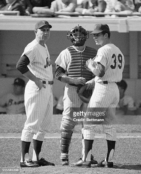 New York, NY: Shea Stadium: Gil Hodges , Mets manager, confers with catcher Jerry Grote and pitcher Gary Gentry at the mound before relief pitcher...