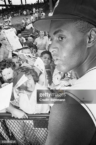 Pittsburgh, PA: Could I have your autograph please?--Fans converge on Pirates star rightfielder Roberto Clemente prior to game with New York Mets...