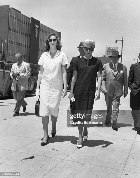 Hollywood, CA: Cheryl Crane talks with her mother, Lana Turner,in the office of attorney William Pollack where depositions are being taken by Pollack...