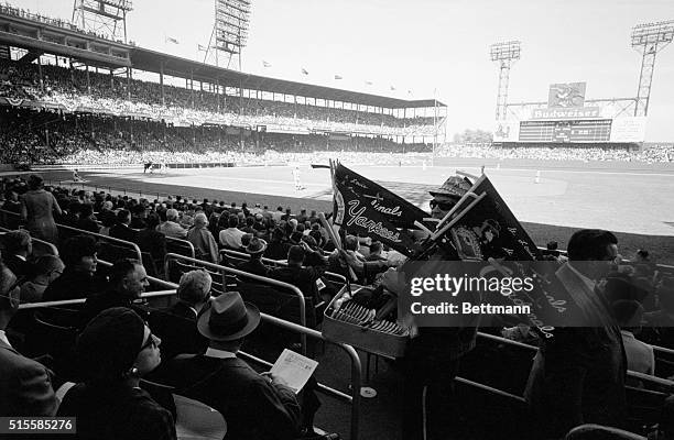 St. Louis, MO: General view of crowded Busch Stadium during the first game of the World Series. Shows pennant vender among seated spectators.