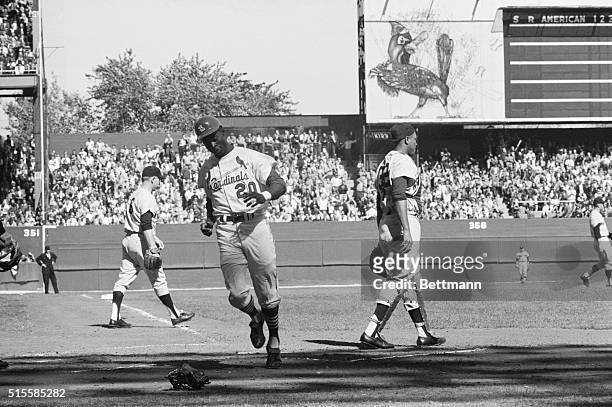 St. Louis, MO: Lou Brock of the Cardinals scores the first run of the World Series opener, without a play on him in the first inning. He raced in...
