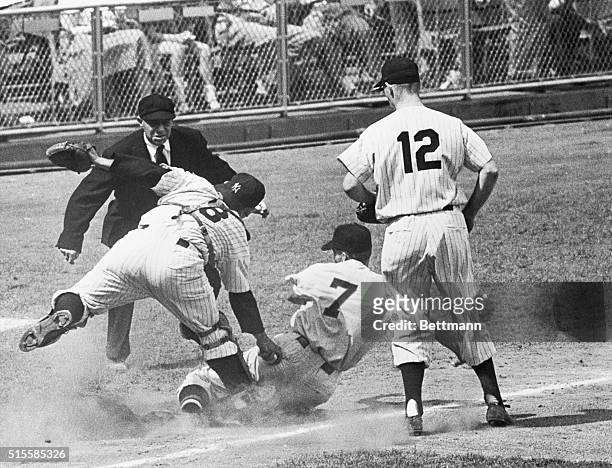 New York, NY: Yankees catcher Yogi Berra tags NATS' Busby near third base, in the fourth inning. McDougald watches as umpire McGowan called the play....