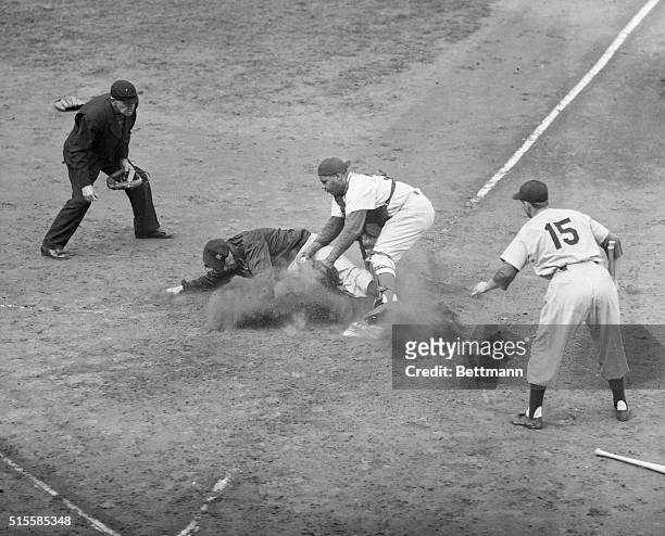 Brooklyn, NY: Yank starting pitcher Ed Lopat slides into home plate on Phil Rizzuto's single to left, only to be put out by Dodger catcher Roy...