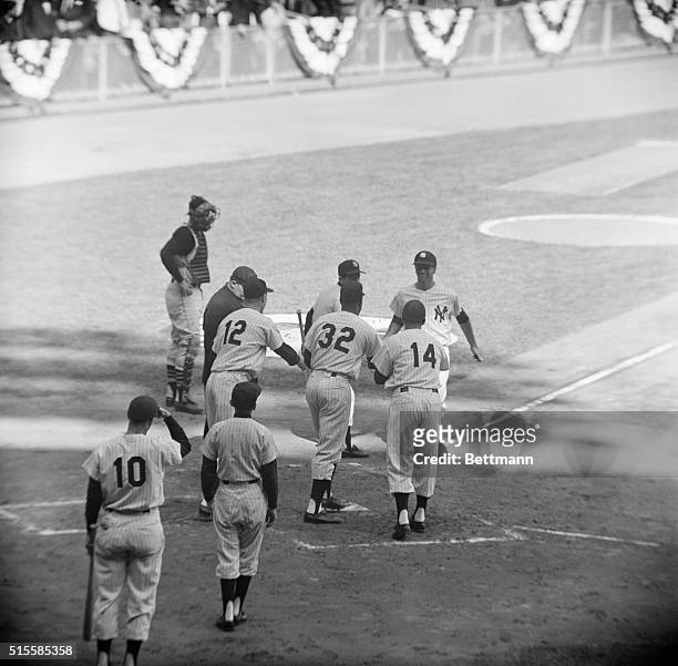 New York, NY: Bobby Richardson is greeted at home plate by Gil McDougald , Elston Howard and Bill Skowron after hitting a grandslam homer in the...