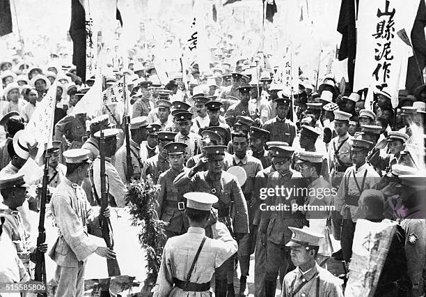 Hsuchowfu, China: Photo shows General Chiang Kai-shek, Commander in Chief of the Nanking Nationalist forces, passing through a crowd of admirers at...