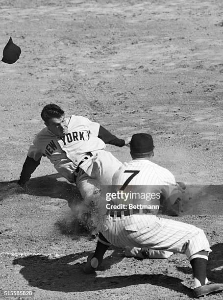 Washington, D.C.: Joe Dimaggio of the World Champion New York Yankees slides safely into third base after McQuinn's single to center in the first...