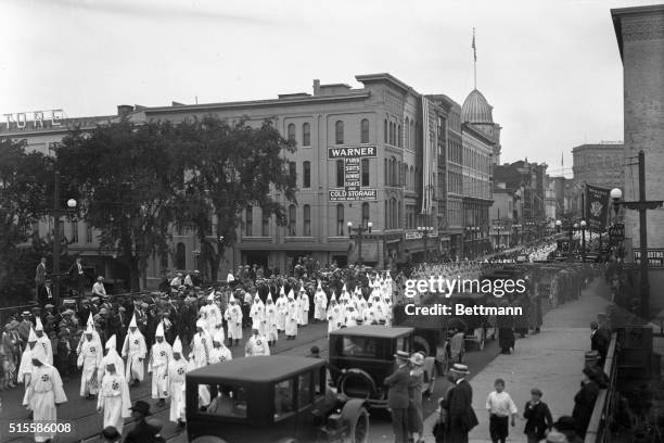 Binghampton, NY: Ku Klux Klan demonstration. Photo shows line of Klansmen parading down street.