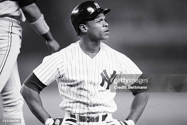 New York, NY:Yankee's left fielder Rickey Henderson shows displeasure after being called out at 1st on a tag by Baltimor Orioles Eddie Murray during...