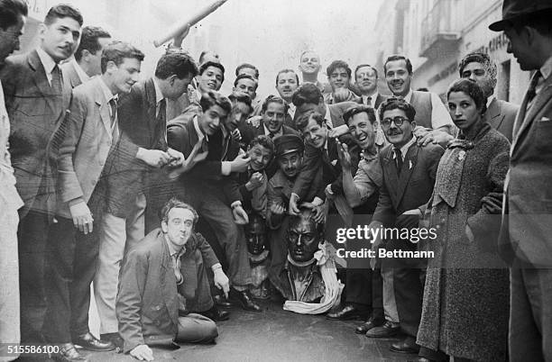 Buenos Aires, Argentina-Students of Argentina gather around a bust of deposed dictator Juna Peron after the succesful revolt against his regime ended...